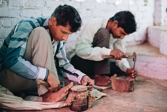 artisans carving and hammering wood