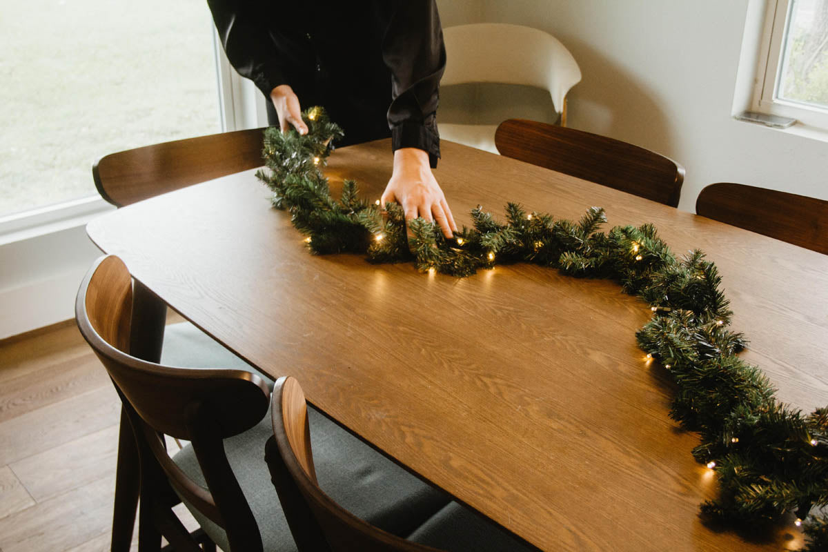 garland being placed on dining room table