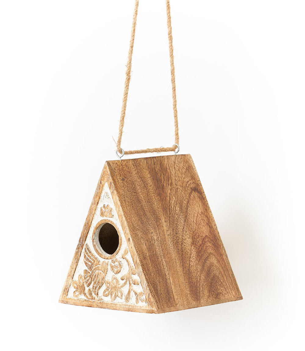 An hand graved bird house this features a traditional, triangular a-frame design with flora and fauna inspired carving on each side and a 1.25” hole in the center.