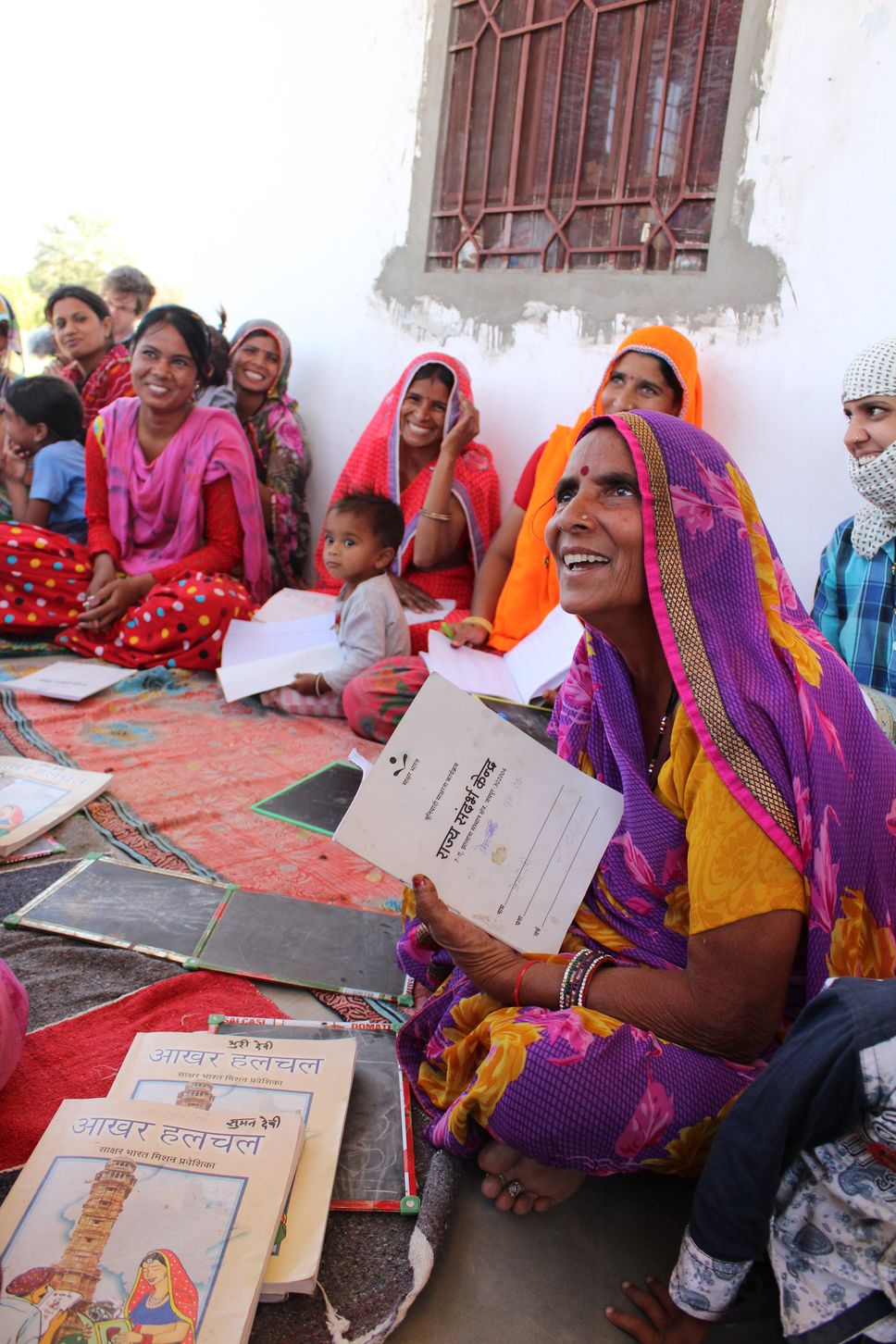female artisans and children at learning program