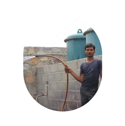 male artisan holding water hose 